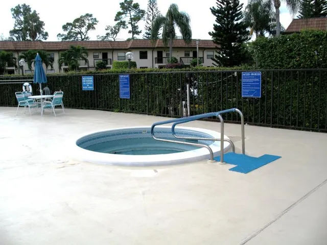 a view of a swimming pool with chairs