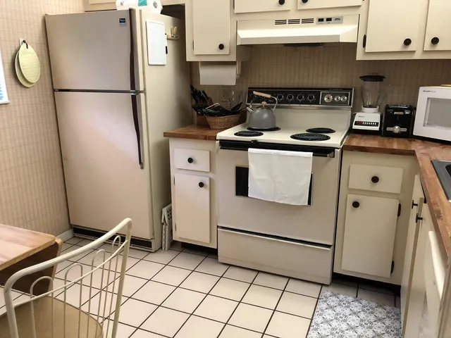 a kitchen with a refrigerator and a stove