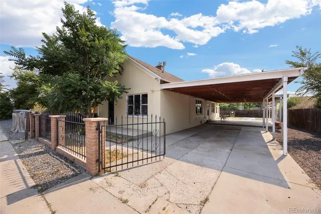 a view of a patio with table and chairs with wooden fence and floor