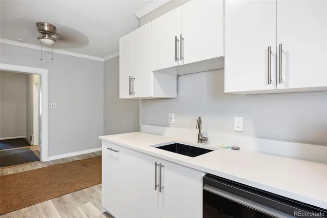 a kitchen with a sink cabinets and white appliances