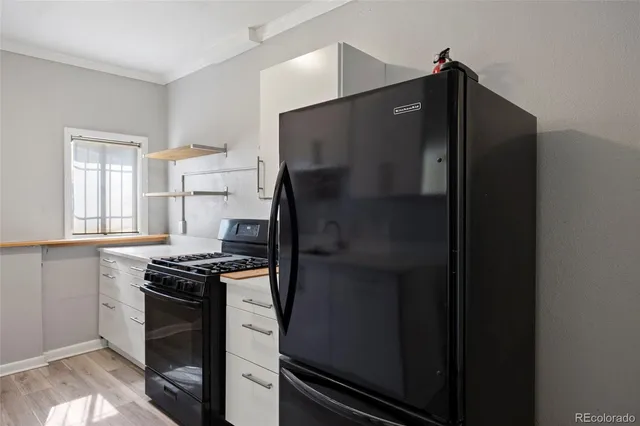a kitchen with stainless steel appliances granite countertop a refrigerator and a stove
