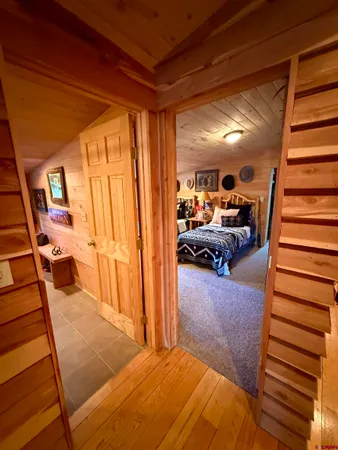 a view of a livingroom with furniture and staircase