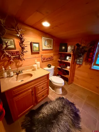 a bathroom with a toilet sink and mirror