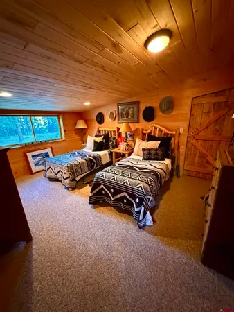 a bedroom with furniture and a flat screen tv