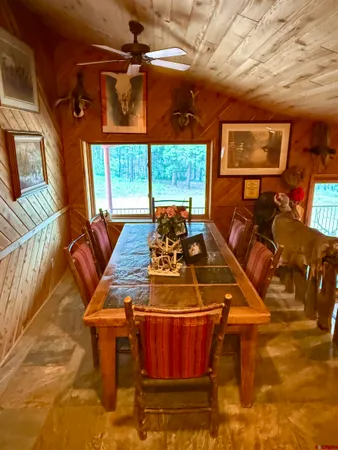 a front view of a room with furniture wooden floor and windows