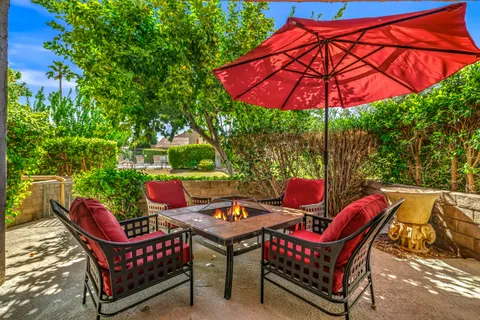 an outdoor sitting area with furniture and wooden deck