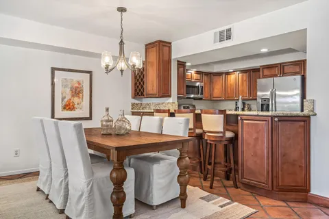 a dining table with chairs and window