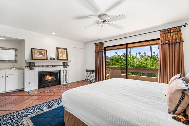 a bed room with a bed and a fireplace