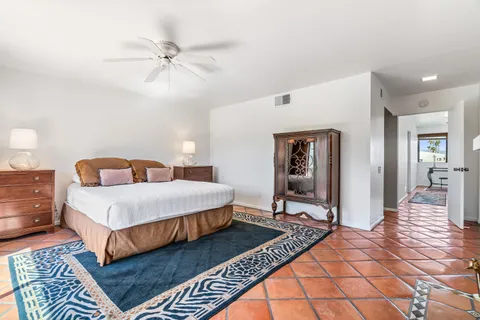 a bedroom with a bed and a mirror