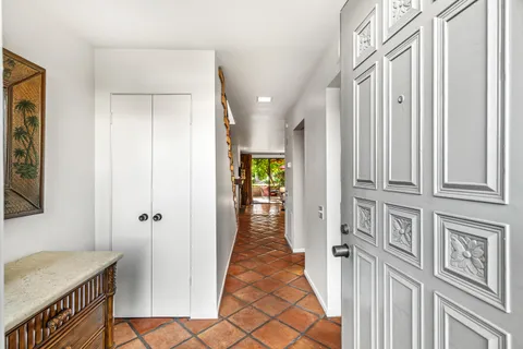 a view of a hallway with a livingroom and furniture