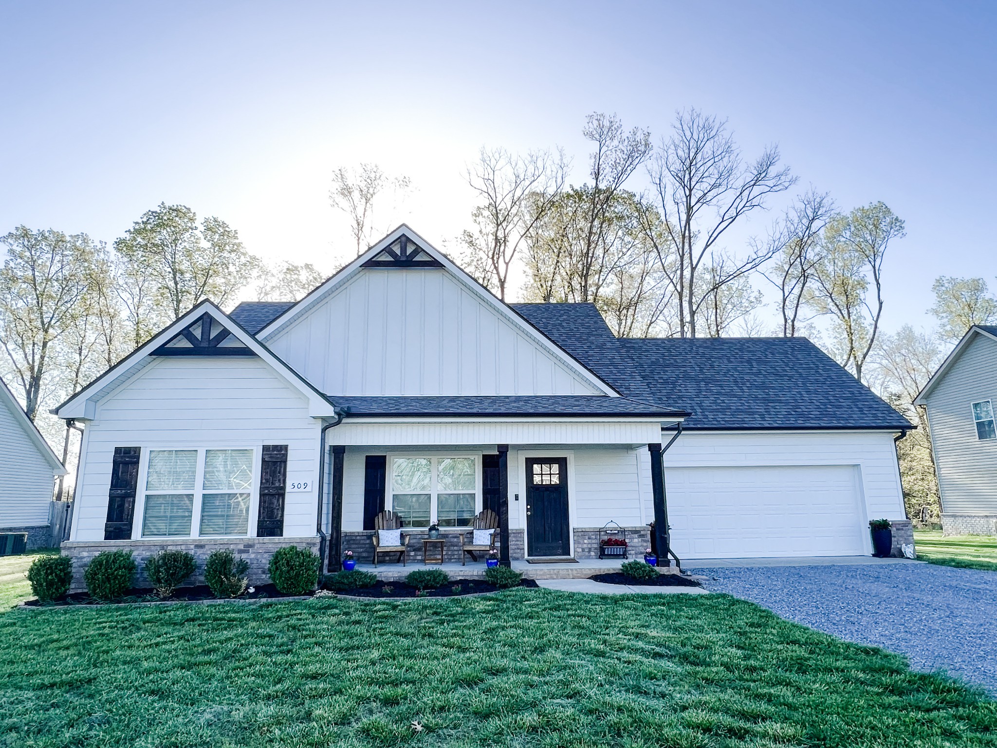 a front view of a house with a garden and yard