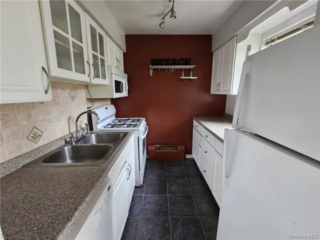 a kitchen with stainless steel appliances granite countertop a sink and dishwasher