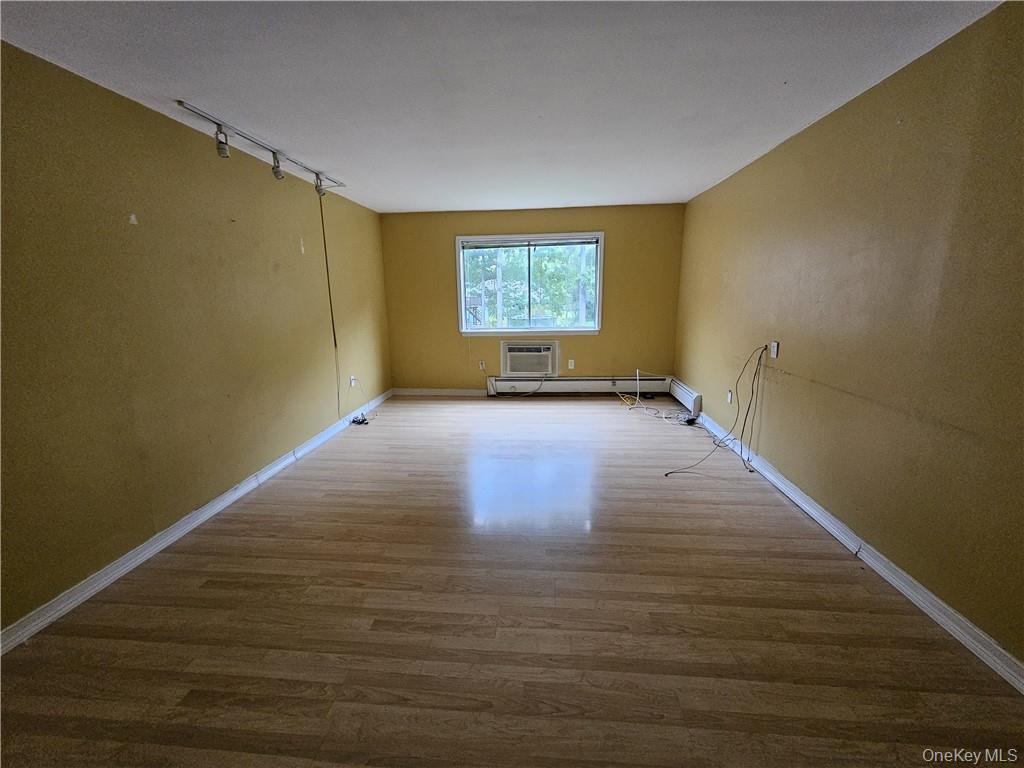 17 Tanager Road, Unit 1704 Monroe, NY 10950 - Photo 9 of 10 a view of an empty room with wooden floor and a window