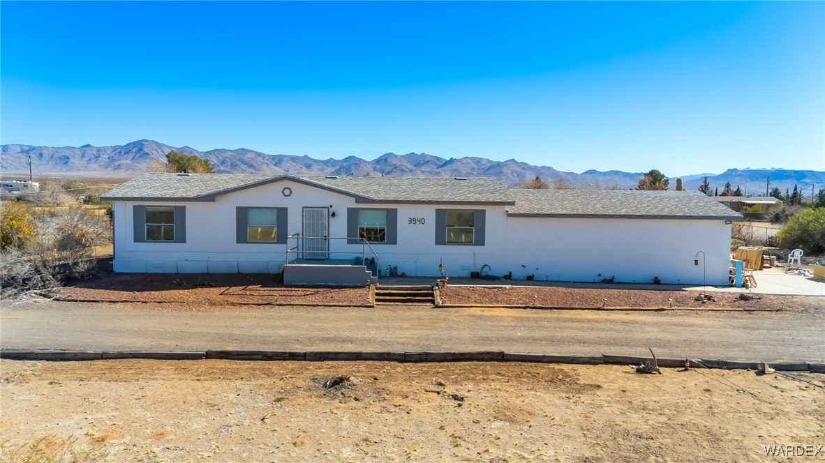 3940 North Santa Maria Road Golden Valley, AZ 86413 - Photo 1 of 35 a front view of a house with a yard