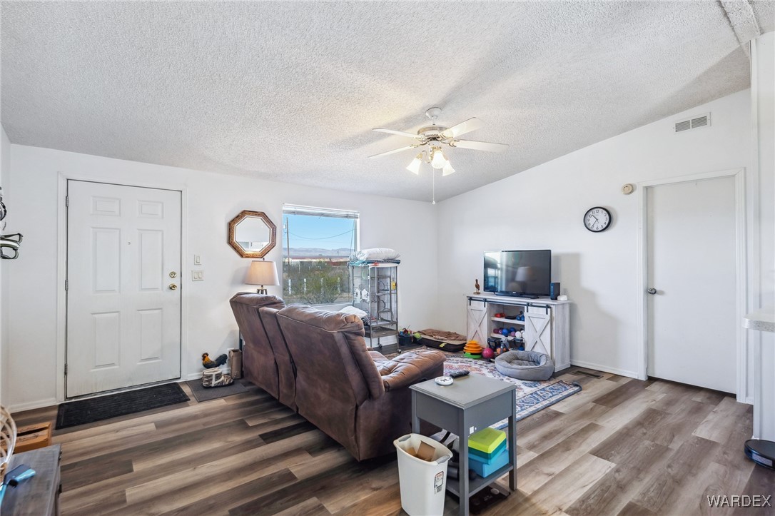 3940 North Santa Maria Road Golden Valley, AZ 86413 - Photo 5 of 35 a living room with furniture and a flat screen tv