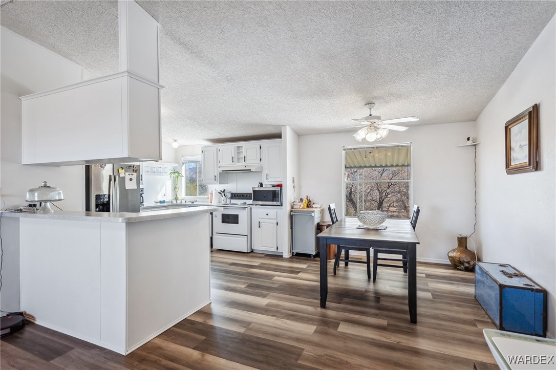 3940 North Santa Maria Road Golden Valley, AZ 86413 - Photo 7 of 35 a kitchen with a table and chairs in it