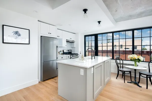a bedroom with a bed and a potted plant
