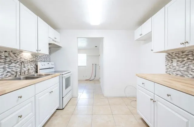 a kitchen with a sink and cabinets