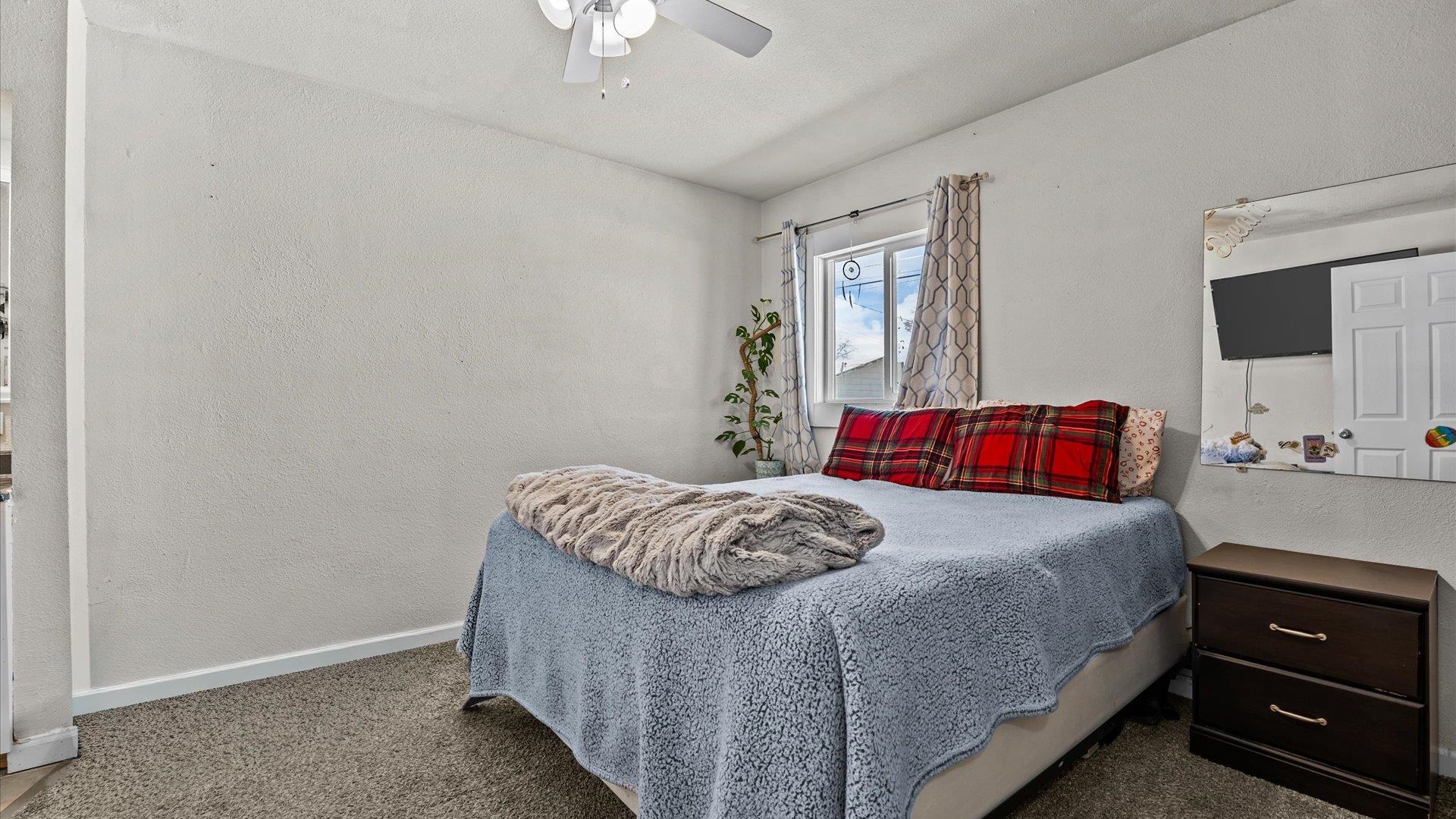 2896 Seely Road Grand Junction, CO 81503 - Photo 11 of 27 a bedroom with a bed and a window