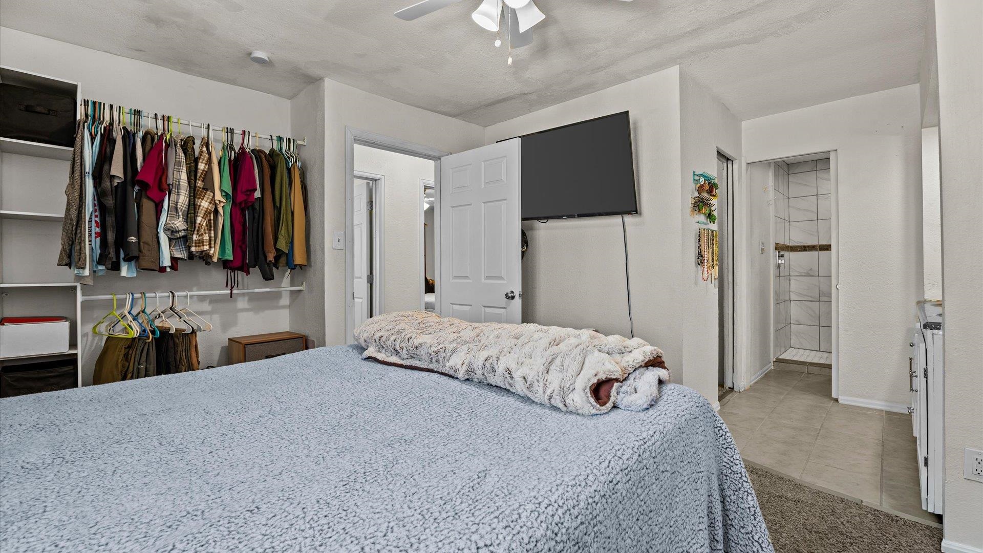 2896 Seely Road Grand Junction, CO 81503 - Photo 12 of 27 a bedroom with a large bed and a large mirror
