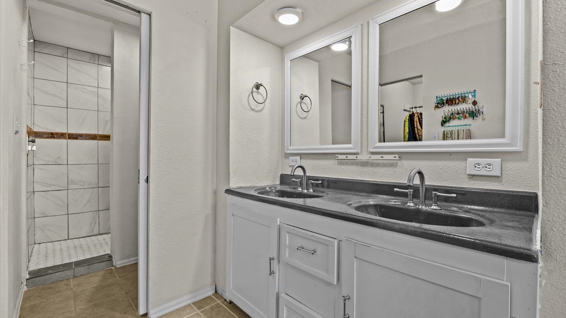 2896 Seely Road Grand Junction, CO 81503 - Photo 13 of 27 a bathroom with a sink and a mirror of shower