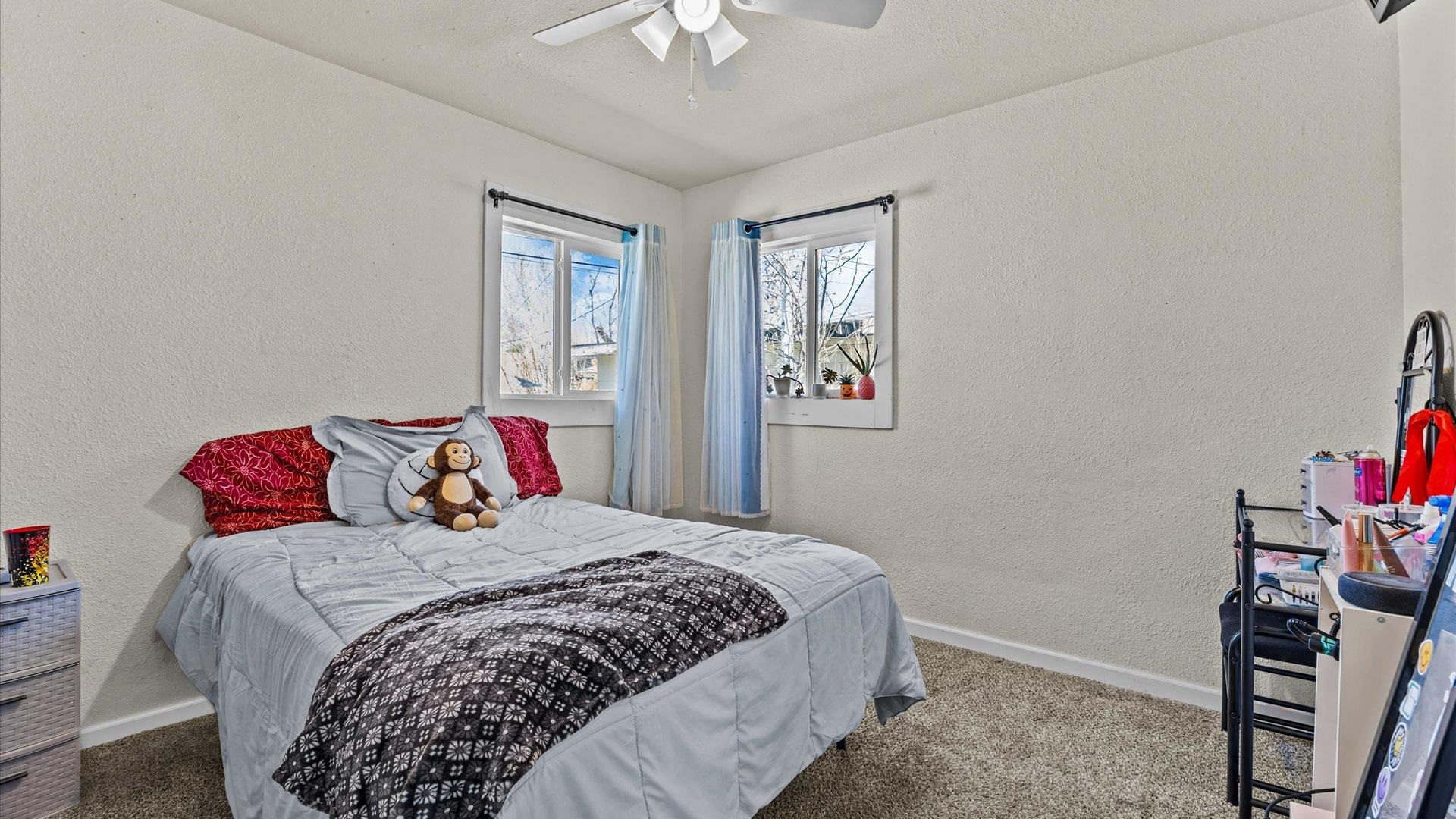 2896 Seely Road Grand Junction, CO 81503 - Photo 15 of 27 a bedroom with a bed and a chandelier