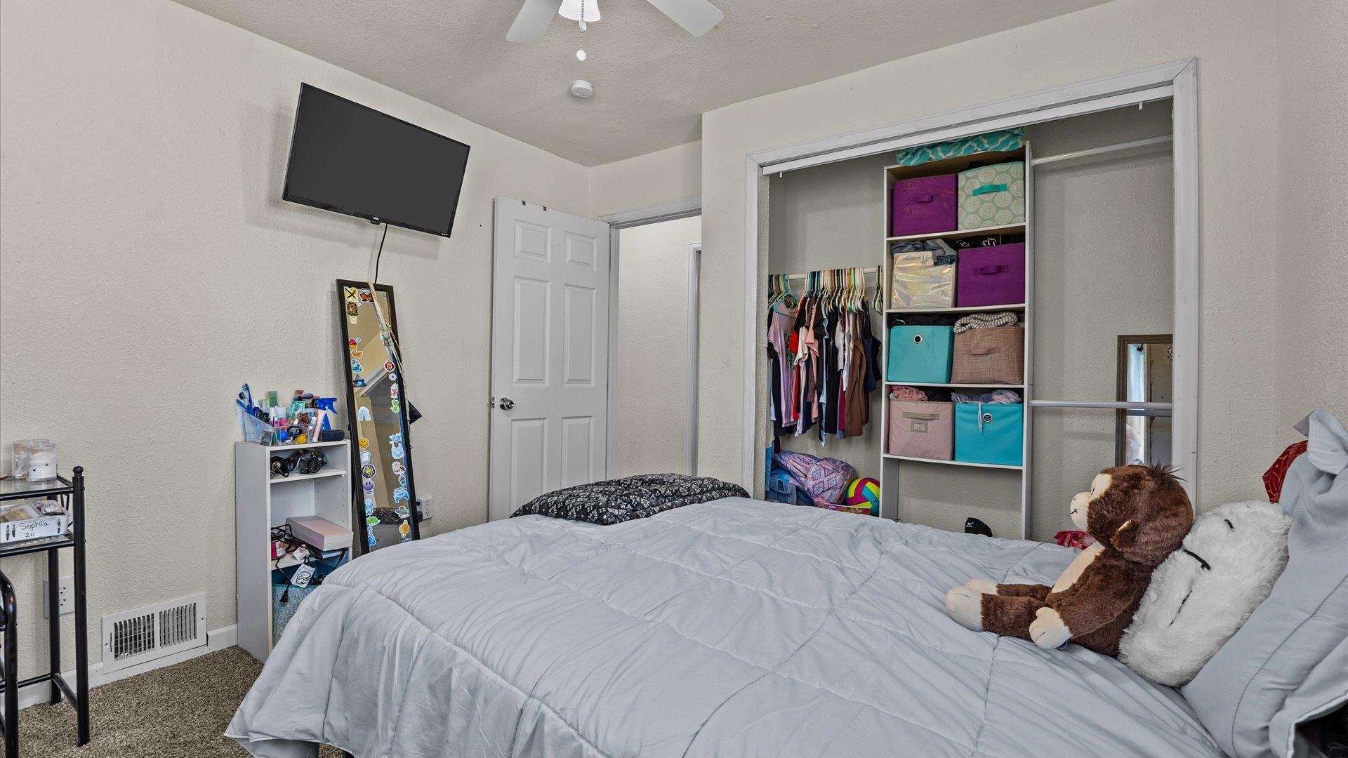 2896 Seely Road Grand Junction, CO 81503 - Photo 16 of 27 a bedroom with a bed and a flat screen tv