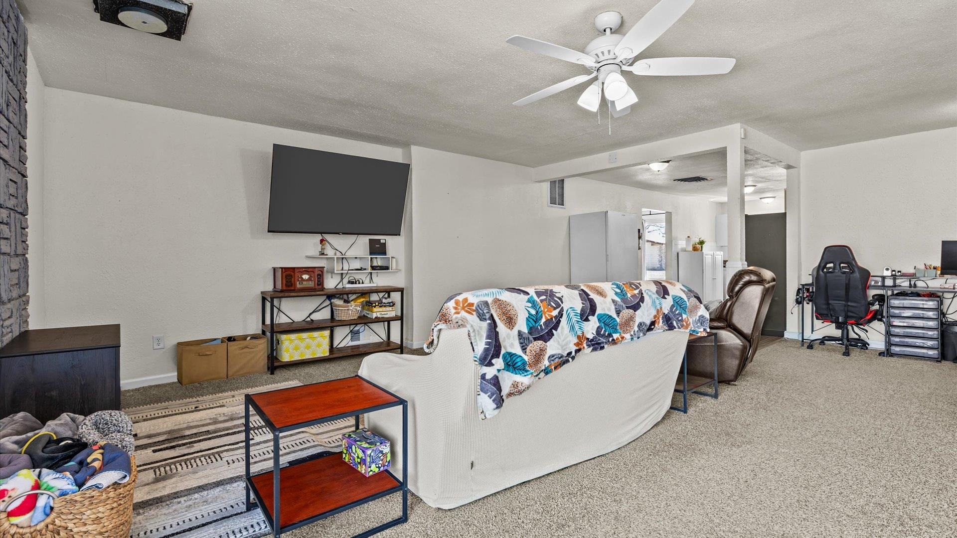 2896 Seely Road Grand Junction, CO 81503 - Photo 19 of 27 a living room with furniture and a flat screen tv