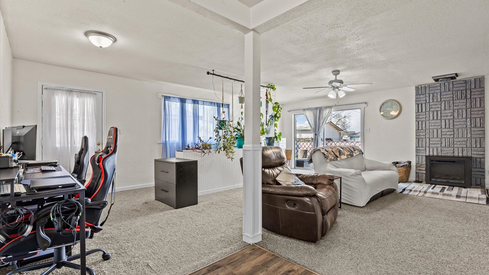 2896 Seely Road Grand Junction, CO 81503 - Photo 20 of 27 a living room with furniture a chandelier and a flat screen tv
