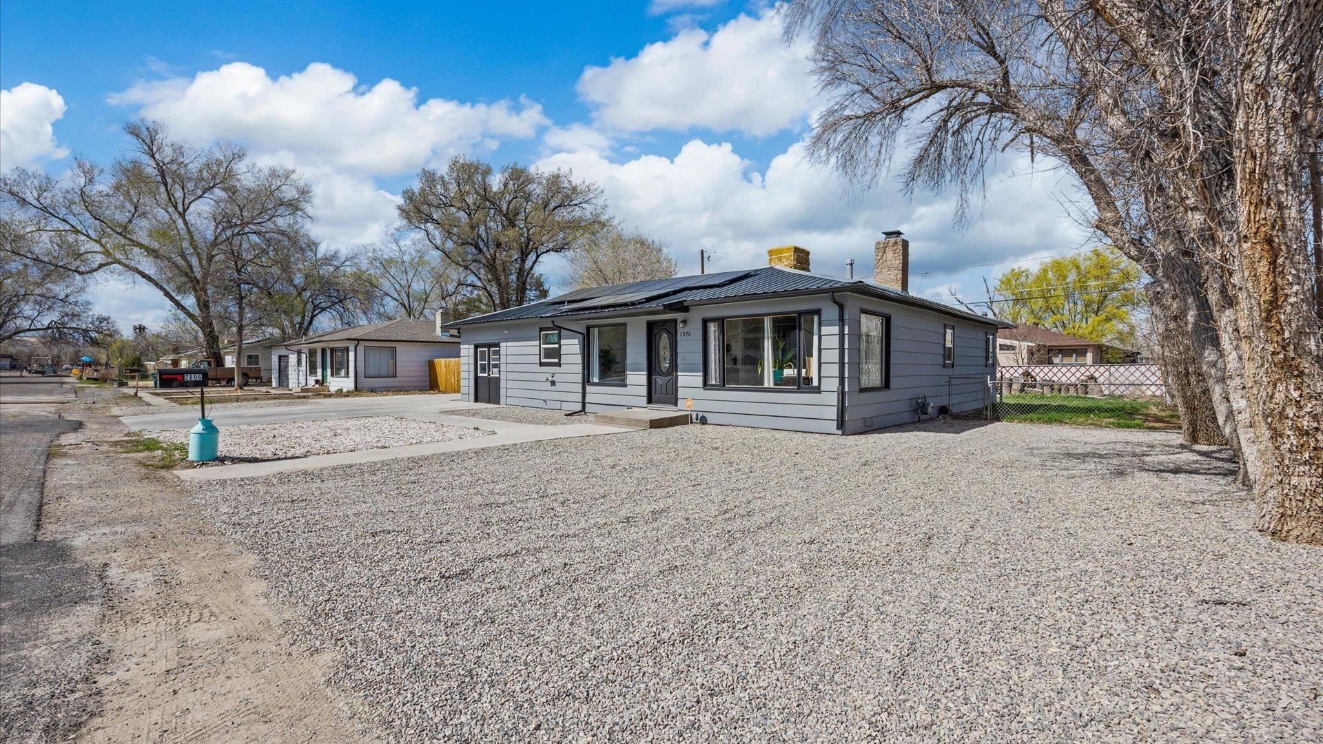 2896 Seely Road Grand Junction, CO 81503 - Photo 26 of 27 a front view of a house with a garden and trees