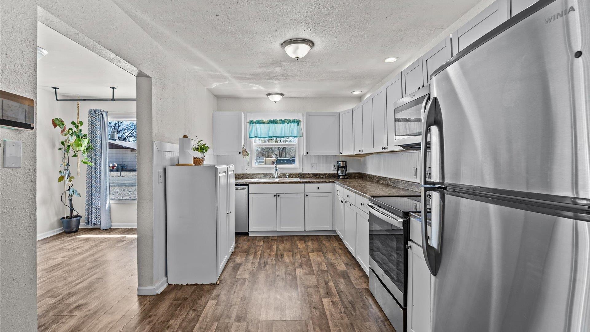 2896 Seely Road Grand Junction, CO 81503 - Photo 5 of 27 a kitchen with a refrigerator a sink and cabinets