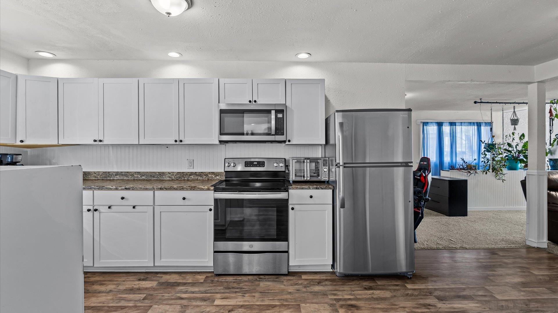 2896 Seely Road Grand Junction, CO 81503 - Photo 10 of 27 a kitchen with stainless steel appliances granite countertop a refrigerator stove and microwave