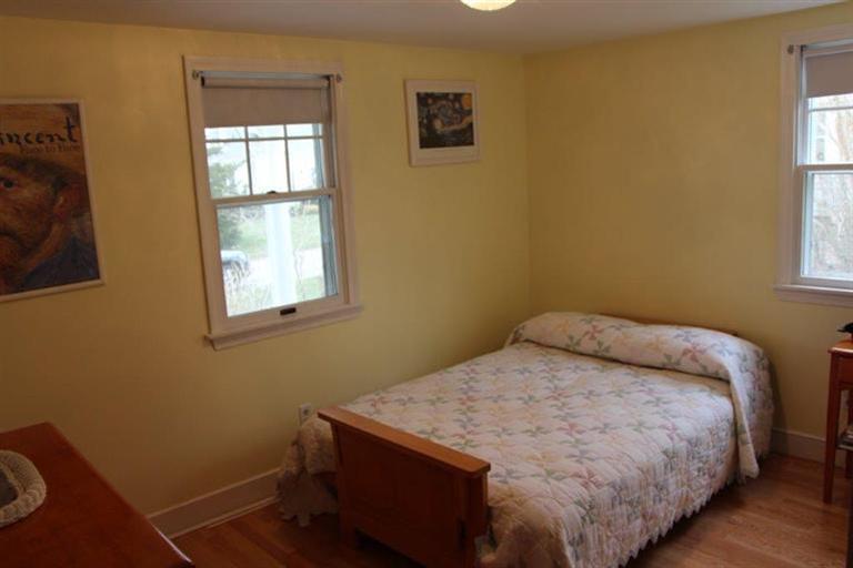137 Leeward Road Bourne, MA 02532 - Photo 17 of 31 a bed sitting in a bedroom next to a window