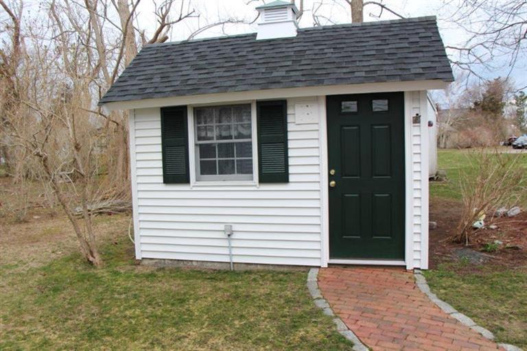 137 Leeward Road Bourne, MA 02532 - Photo 9 of 31 a front view of a house with a garden
