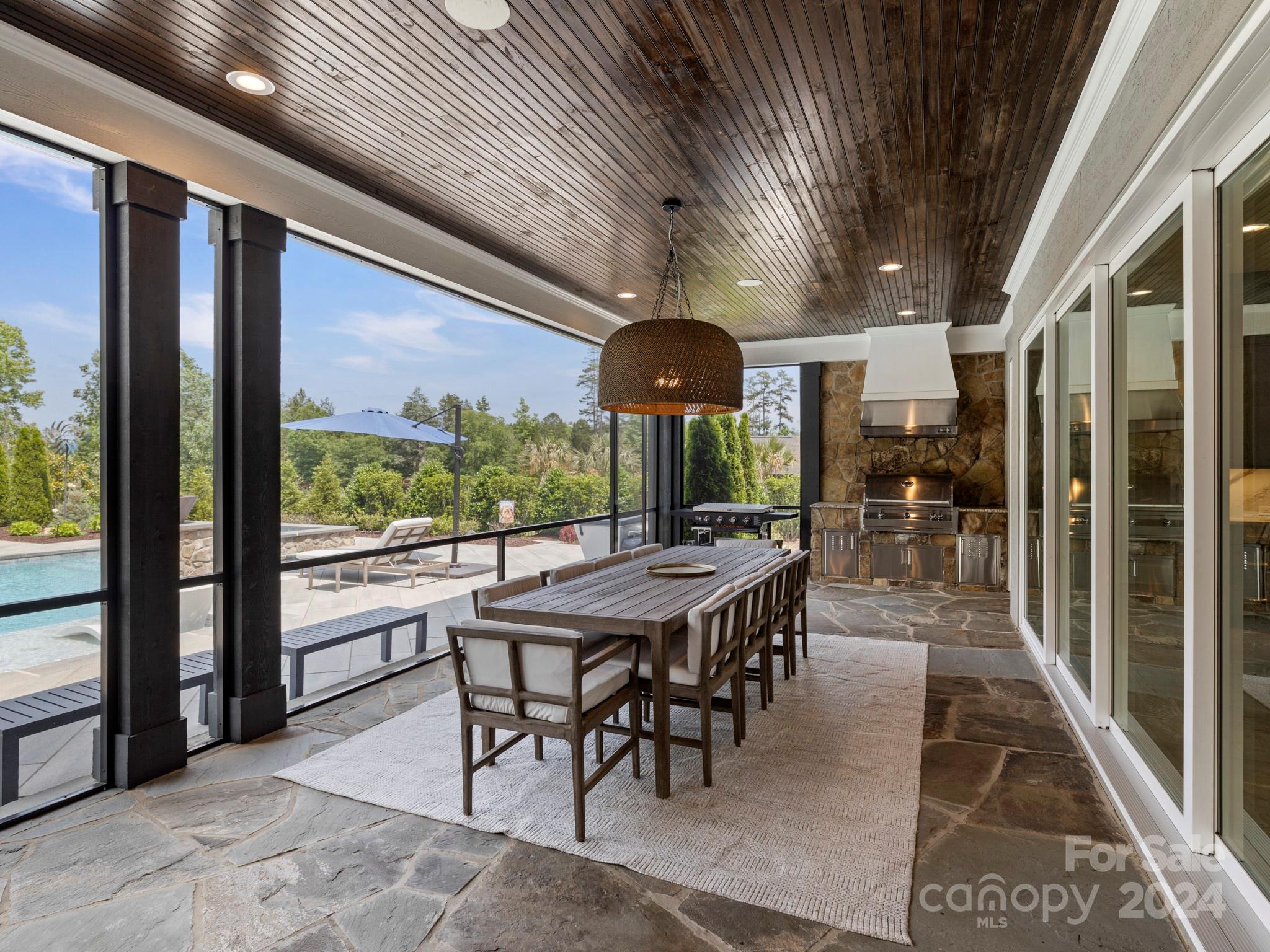 16520 Reinsch Drive Davidson, NC 28036 - Photo 25 of 37 a view of a dining room with furniture large windows and wooden floor
