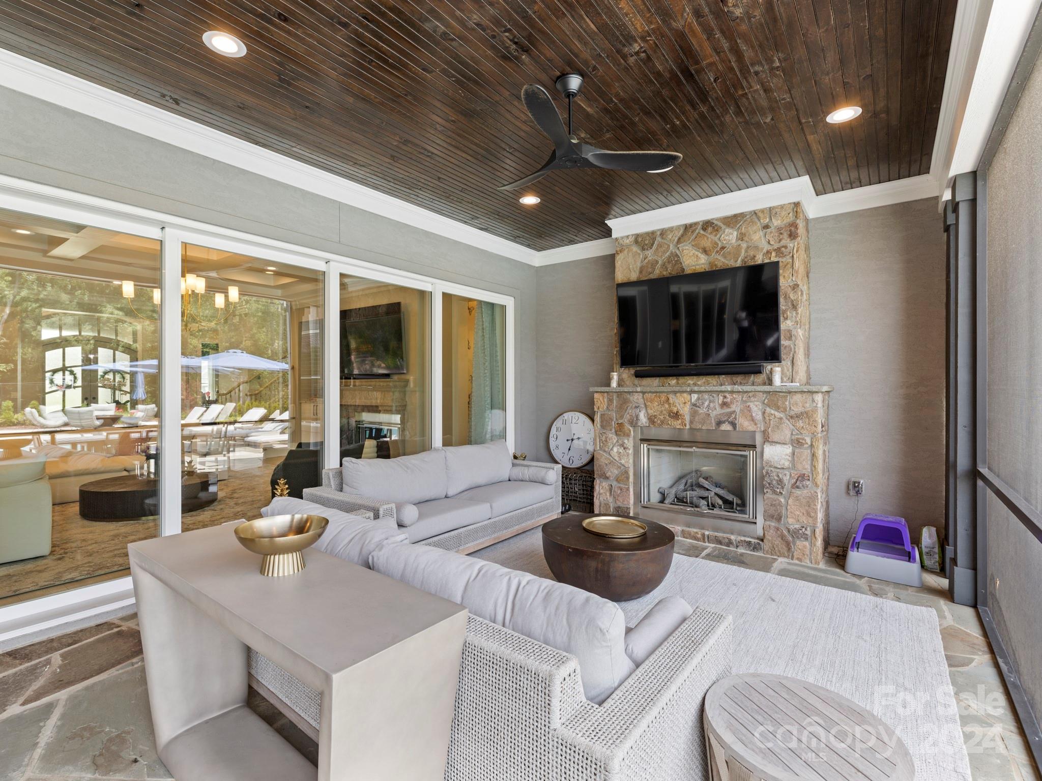 16520 Reinsch Drive Davidson, NC 28036 - Photo 26 of 37 a living room with furniture a fireplace and a flat screen tv