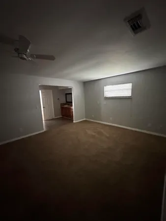 an empty room with a empty space and windows