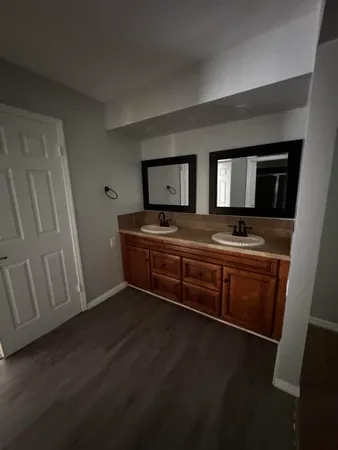 a room with wooden floor and electronic appliances