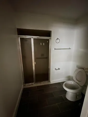 a bathroom with a toilet and a mirror