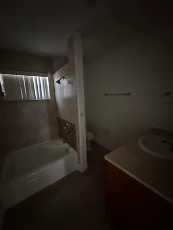 a bathroom with a bathtub and sink