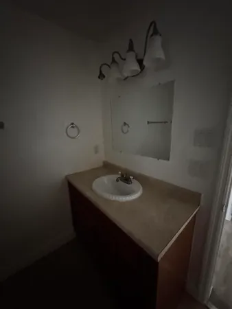 a bathroom with a sink and mirror