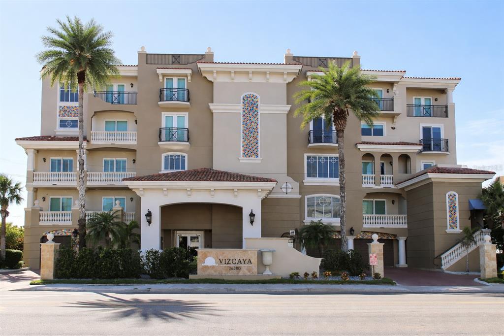 a front view of a building with glass windows and a table