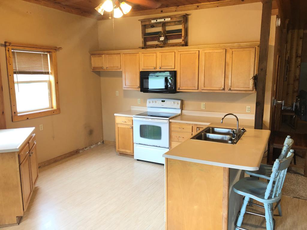 4659 Forest Road Cooksburg, PA 16217 - Photo 4 of 20 a kitchen with stainless steel appliances a stove a sink a microwave and a refrigerator