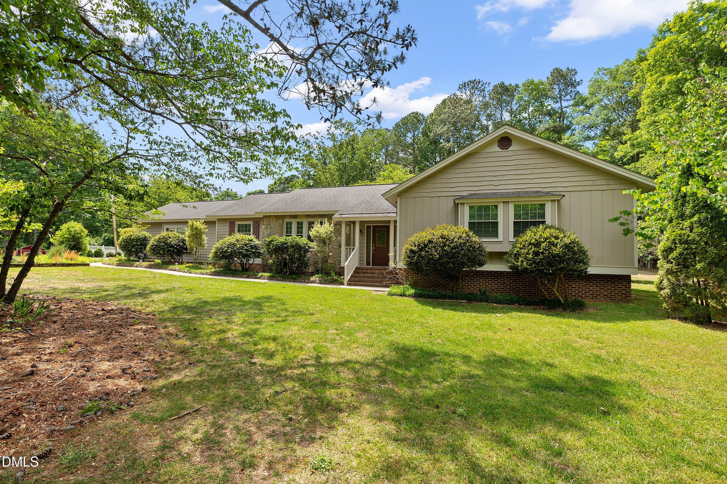 8133 Holly Forest Road Wake Forest, NC 27587 - Photo 1 of 50 a front view of a house with yard and green space