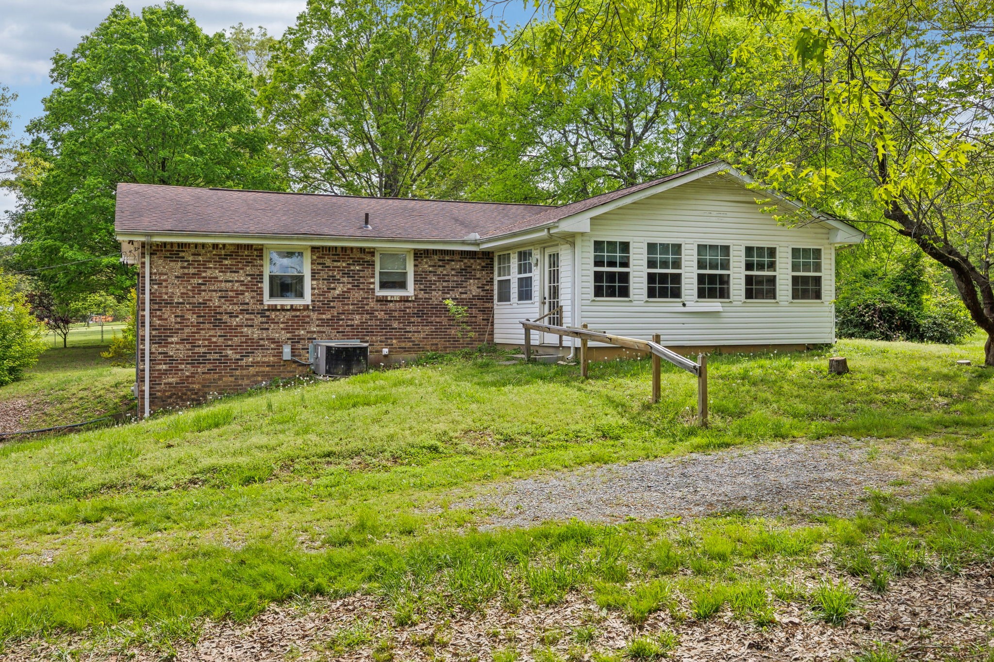 10924 Rials Branch Road Bon Aqua, TN 37025 - Photo 19 of 34 a front view of a house with a yard