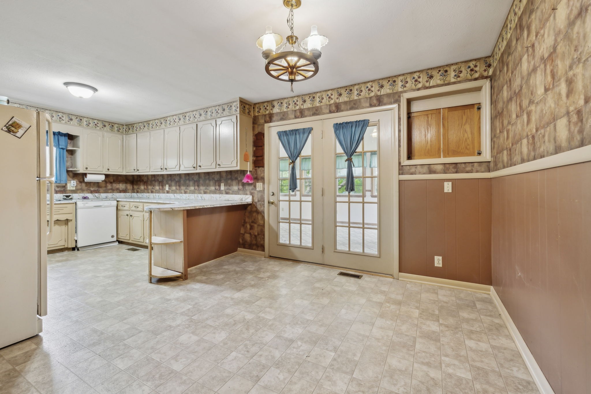 10924 Rials Branch Road Bon Aqua, TN 37025 - Photo 10 of 34 a view of a kitchen with a sink and dishwasher cabinet with wooden floor