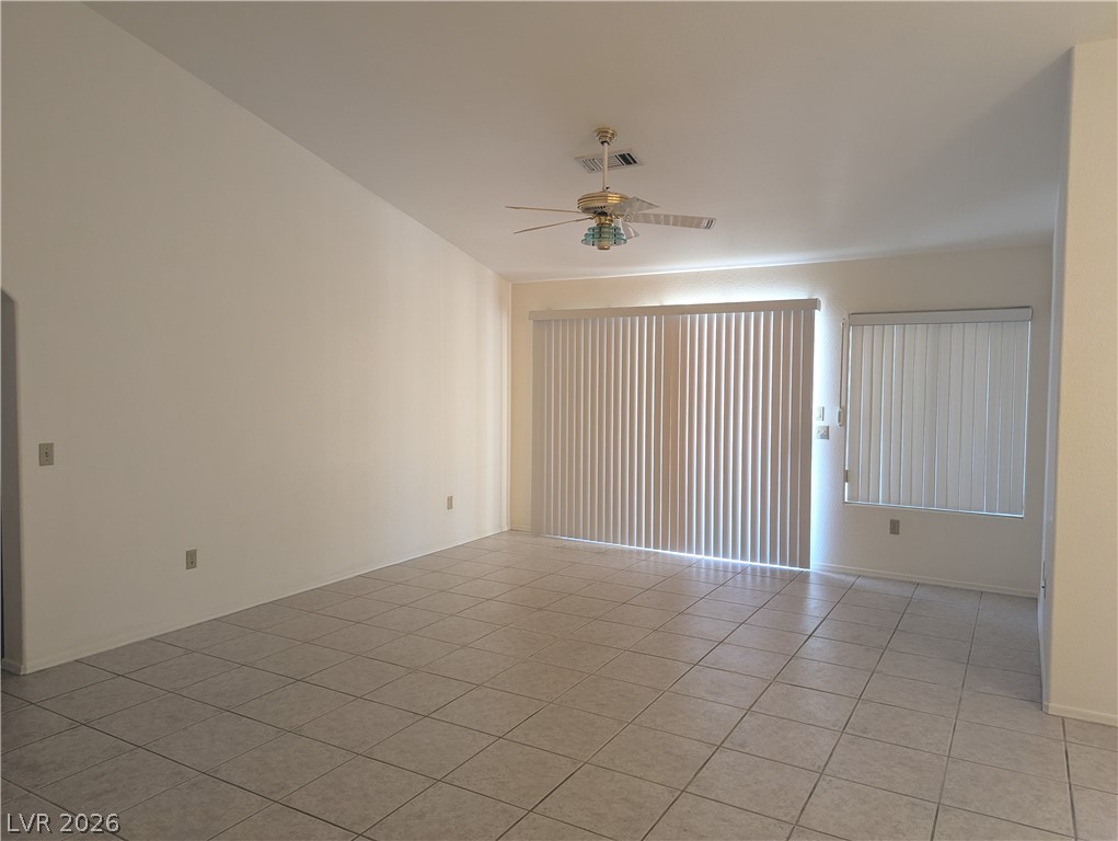 9433 Quail Ridge Drive Las Vegas, NV 89134 - Photo 3 of 23 A versatile living area with light-toned tiled flooring and convenient vertical blinds.