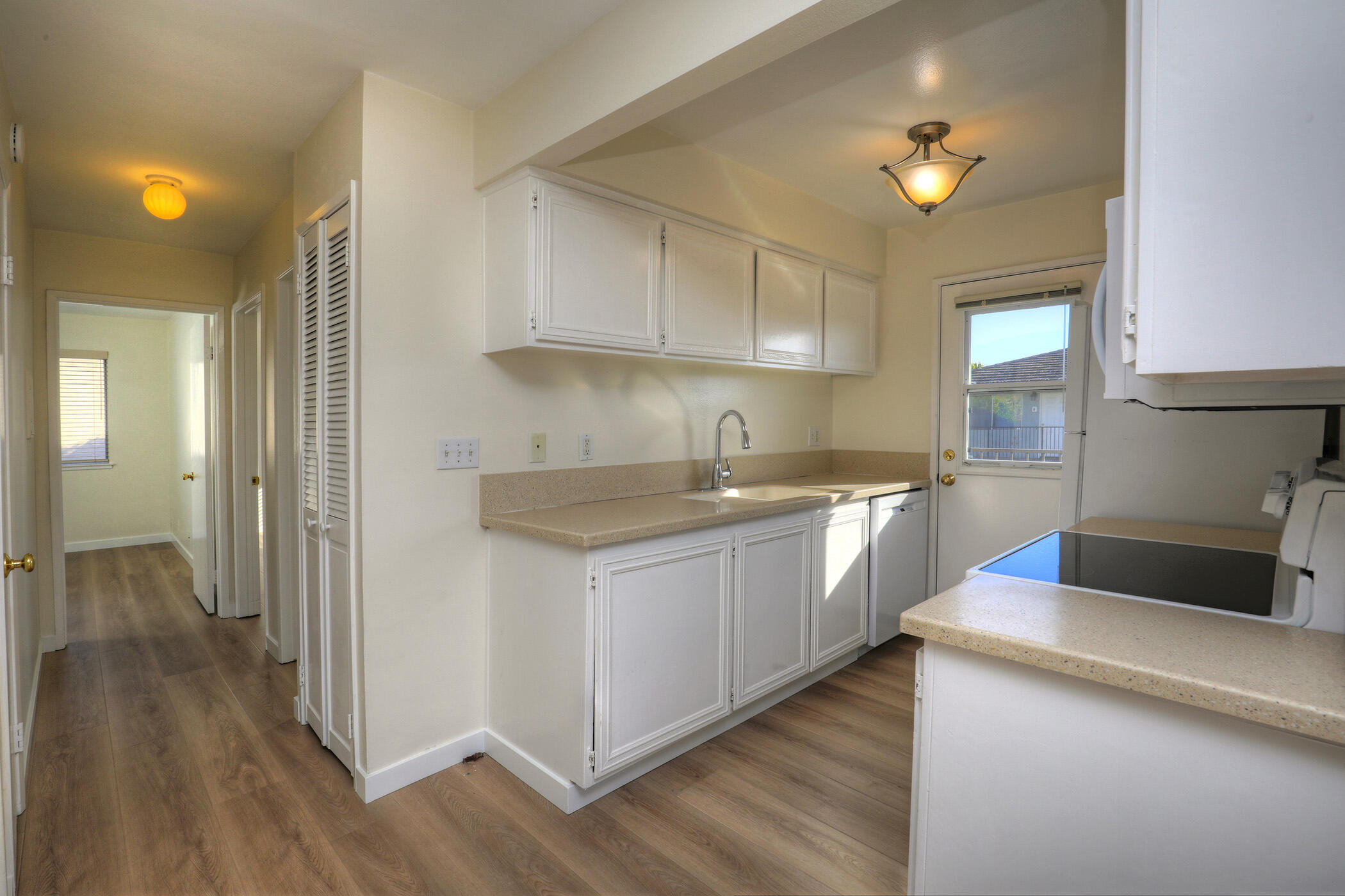 5945 Hickory Street, Unit 4 Carpinteria, CA 93013 - Photo 6 of 19 a kitchen with a sink cabinets and wooden floor