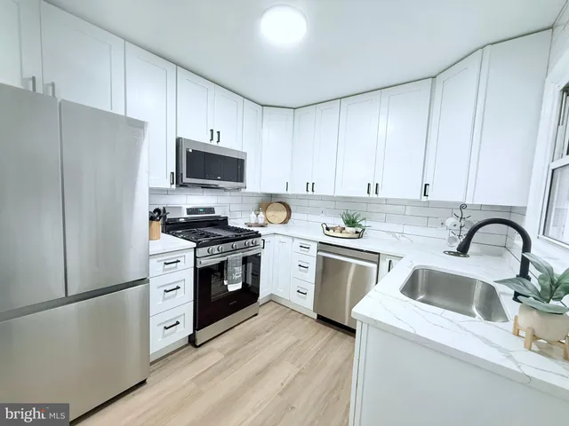 a kitchen with a refrigerator stove and sink