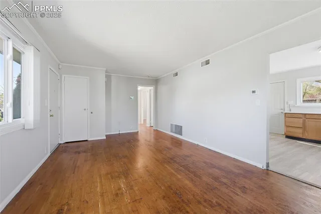 a kitchen with stainless steel appliances granite countertop a sink a stove cabinets and wooden floor